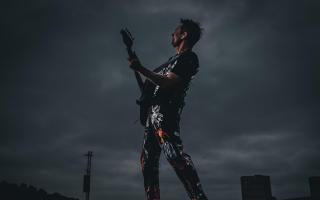 Muse frontman Matt Bellamy performing at Glasgow's Bellahouston park