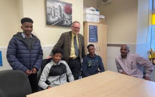 Day with his constituent Mr Omar, right, and his three sons who were stranded in Sudan