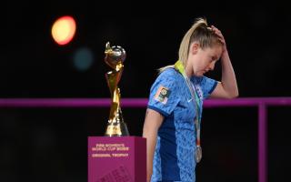 Keira Walsh walks by the Women's World Cup trophy following England's loss in the final to Spain