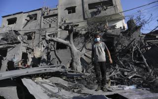 A Palestinian boy stands amid the destruction after an Israeli strike in Rafah, Gaza Strip