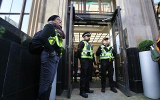 Police were pictured on the scene at AIG's insurance company offices