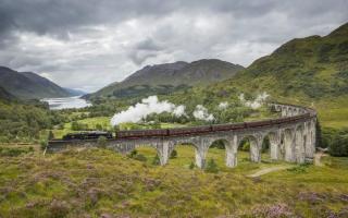 The world famous train crosses the Glenfinnan Viaduct