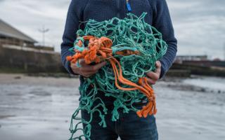 Ally Mitchel from Ocean Plastic Pots holding reclaimed fishing net