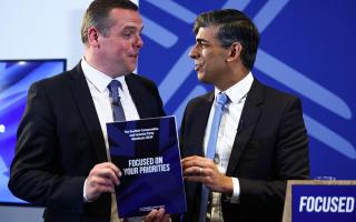 Scottish Conservative leader Douglas Ross and British Prime Minister Rishi Sunak pose with a copy of The Scottish Conservative and Unionist Party Manifesto