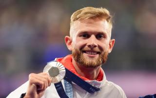 Josh Kerr with his silver medal following the Men's 1500m Final at the Stade de France