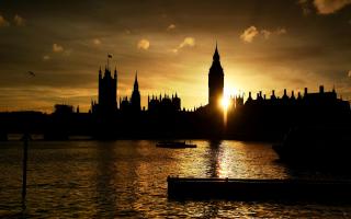 The sun sets behind the Houses of Parliament in London