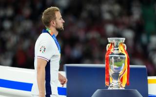 England striker Harry Kane walks past the Euro 2024 championship trophy