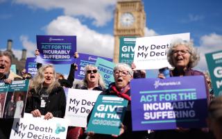 Campaigners in support of voluntary euthanasia protest outside Parliament in Westminster