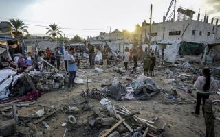 Palestinians inspect damage in the courtyard of Al Aqsa Martyrs hospital