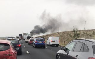 Photo of traffic and a plume of black smoke from the fatal crash on the M6