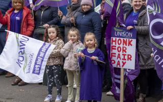 Striking school support workers take part in a demonstration outside First Minister John Swinney's constituency office in Blairgowrie