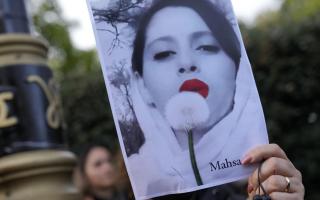 Demonstrators hold placards outside the Iranian Embassy in London