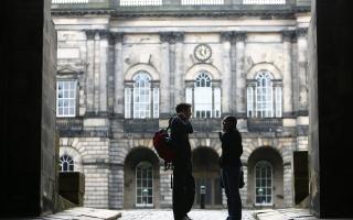 Edinburgh University students at Old College sunday wait for the library to open..