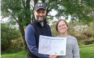 Ian and Eve with their NatureScot certificate for completing all 29 of Scotland’s Great Trails